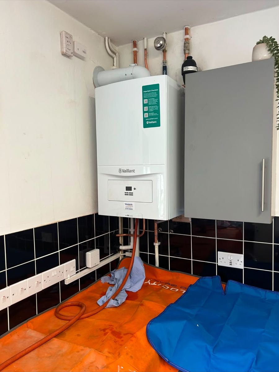 Boiler installation with dust sheets protecting the floor