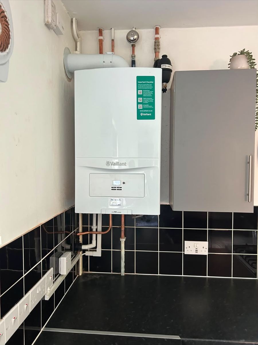 Combi boiler installed in a tiled kitchen