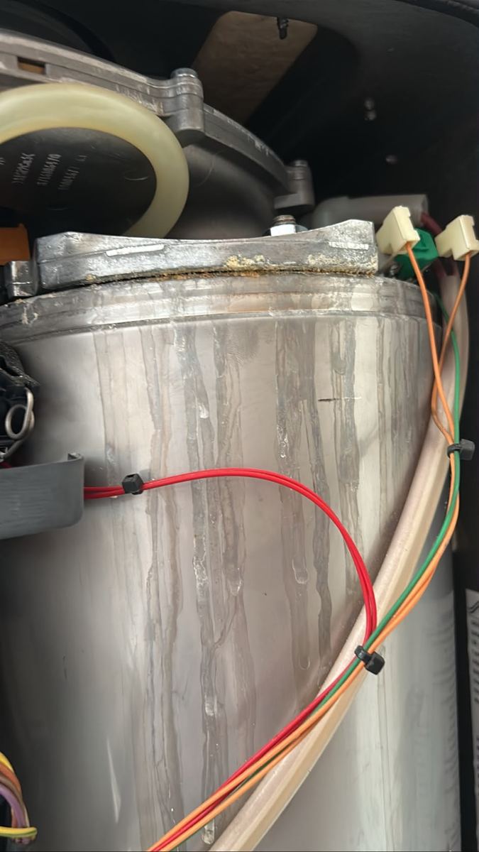 Hot water cylinder wiring being checked